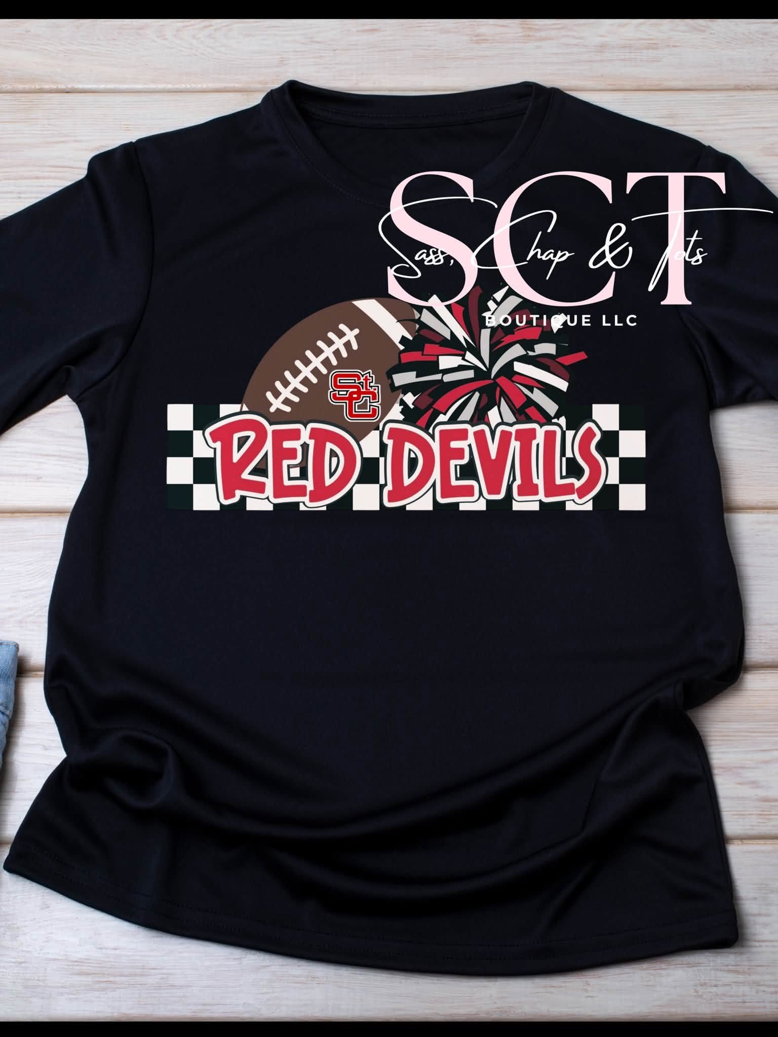 Black graphic tee with Red Devils football and pom-pom design on checkered banner