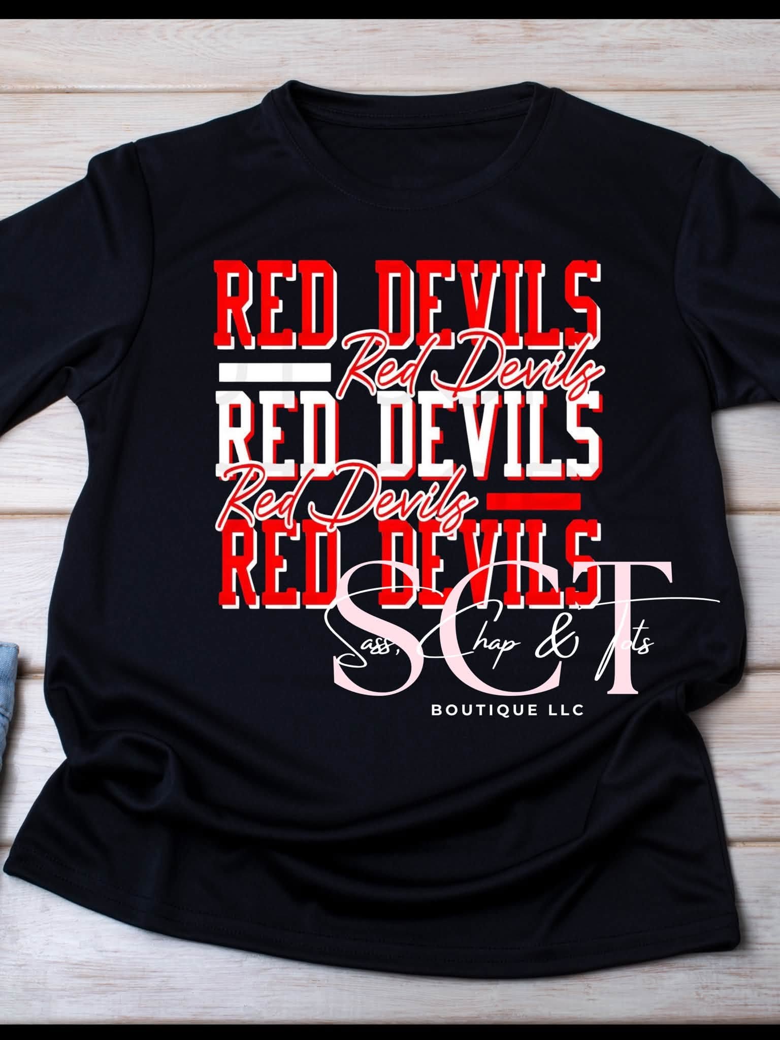 Black graphic tee with stacked Red Devils block lettering and cursive script in red and white